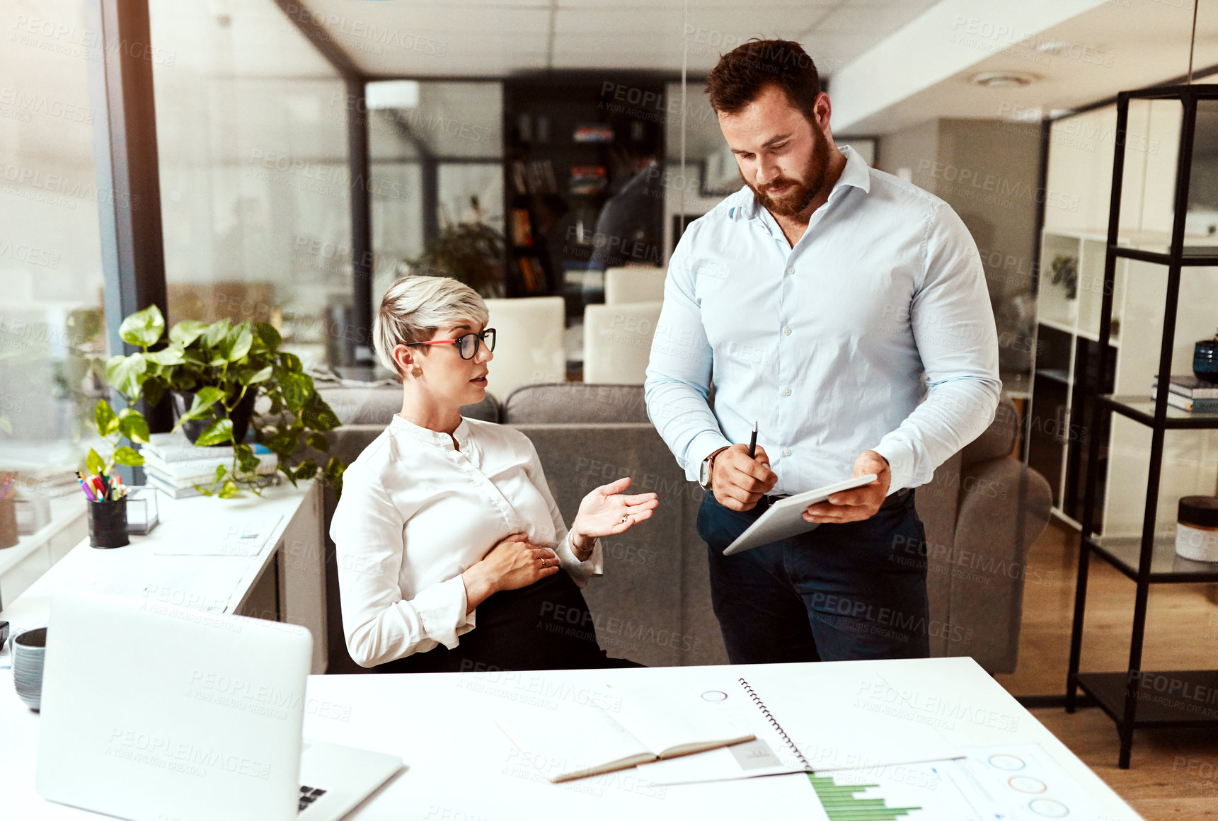 Buy stock photo Shot of two businesspeople having a discussion in an office