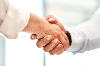 Buy stock photo Closeup shot of two unrecognisable businesspeople shaking hands
