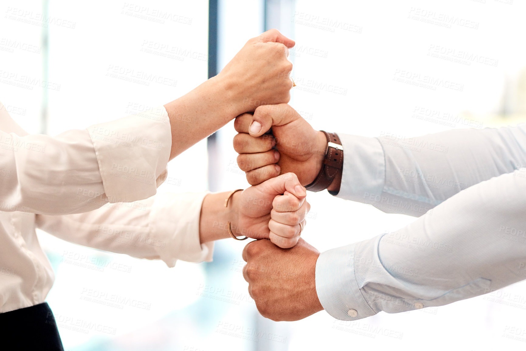 Buy stock photo Closeup shot of two unrecognisable businesspeople stacking their fists on top of each other