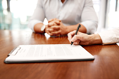 Buy stock photo Closeup shot of two businesspeople going through paperwork together in an office