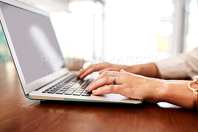 Buy stock photo Closeup shot of an unrecognisable businesswoman using a laptop in an office