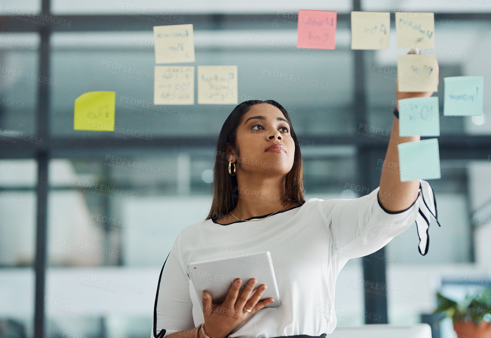 Buy stock photo Glass wall, sticky note and businesswoman with tablet in office with information for research on media project. Board, creative and public relations officer working on press report in workplace.