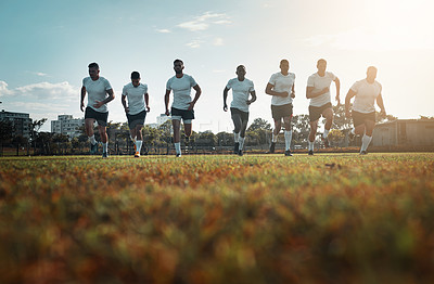 Buy stock photo Rearview shot of a group of young rugby players running on a field