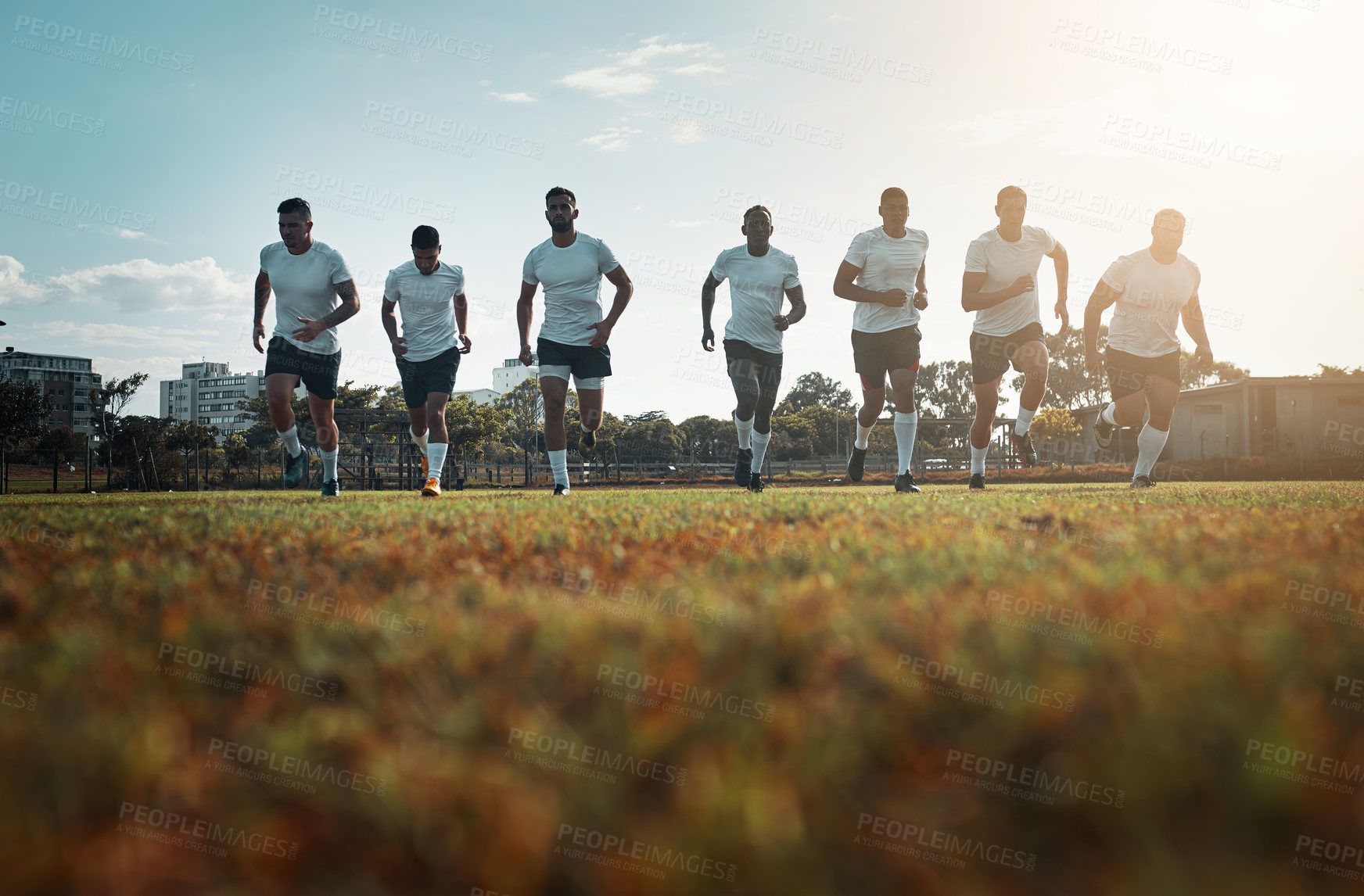 Buy stock photo Rugby, running or men on field for practice training, competition or game routine. Start, professional athletes or strong players on outdoor stadium with teamwork to begin workout or fitness exercise