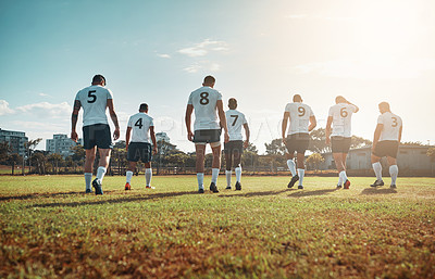 Buy stock photo Rearview shot of a group of young rugby players walking on a field