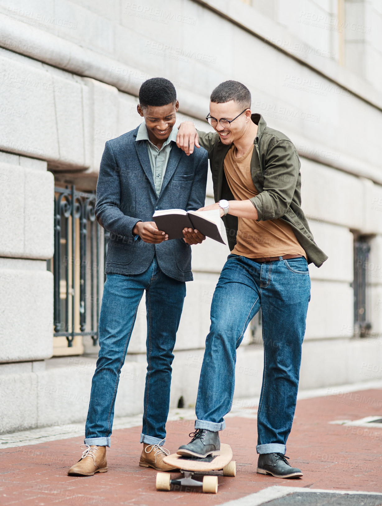 Buy stock photo Shot of two young businessmen having an informal meeting against an urban background