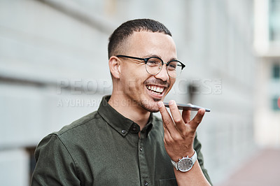 Buy stock photo Young, professional and happy businessman using a phone outdoors. Positive male smiling while speaking on a call. Handsome guy standing alone outside while using technology to communicate with family