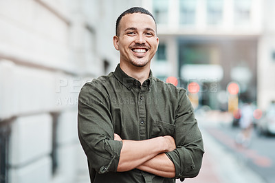 Buy stock photo Business man standing with arms crossed, looking confident and proud in the city alone. Portrait of a black male entrepreneur or worker showing vision, ambition and success with arms folded downtown 