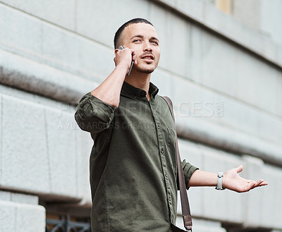 Buy stock photo Lost man, traveler or tourist talking on a phone call asking for directions in a new city. A confused young male on vacation in an urban town looking around to find his hotel or the airport