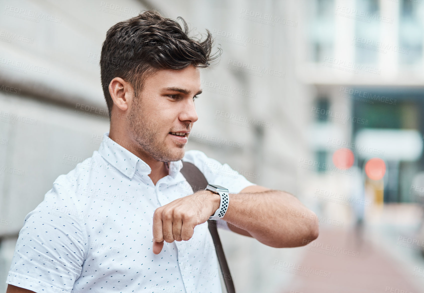 Buy stock photo Chatting on a smartwatch with a young creative business man or intern commuting in the city. Hailing a cab, taxi or ride with an app on wireless technology. Male employee travelling to and from work