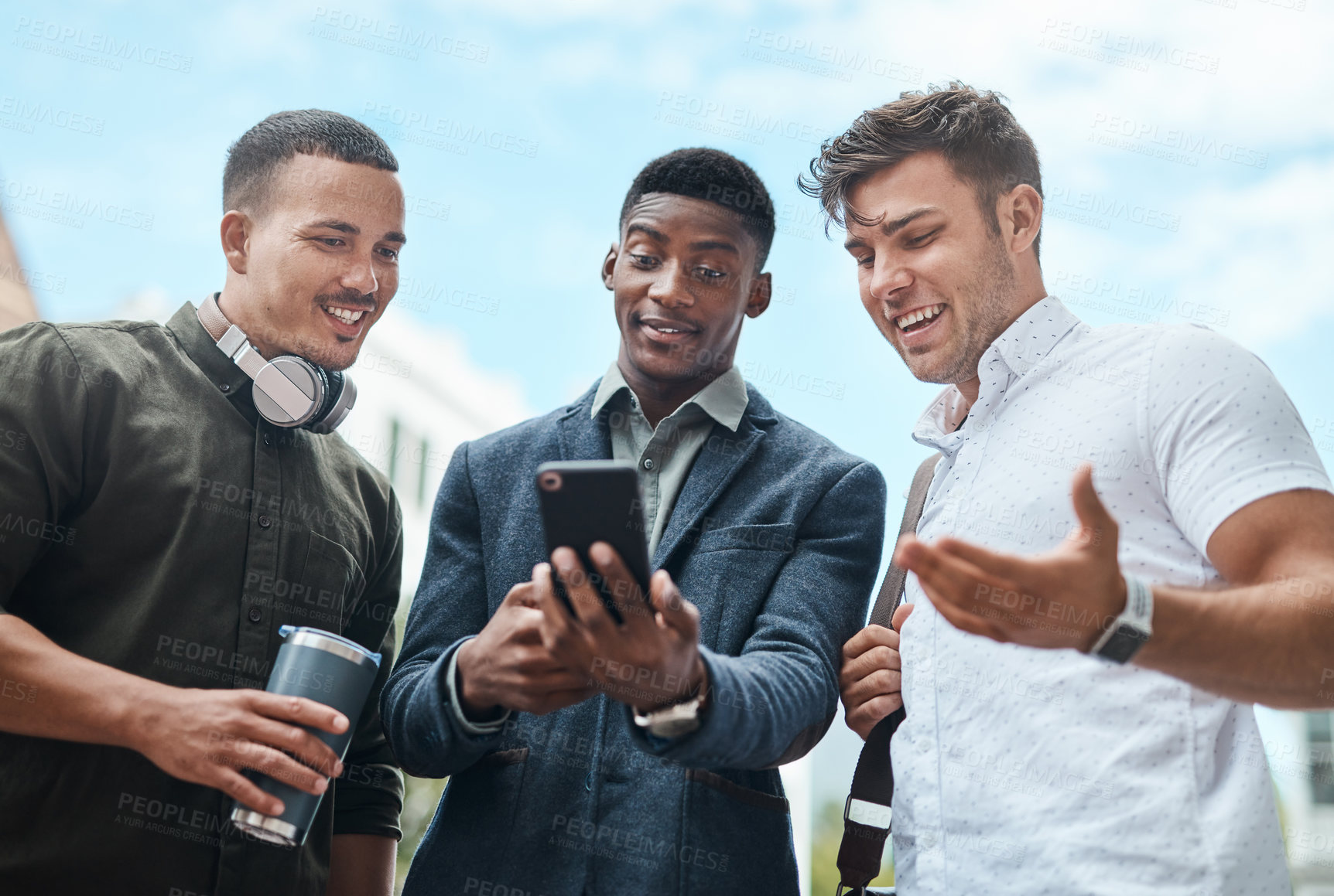Buy stock photo Shot of a group of businesspeople using a smartphone together against an urban background