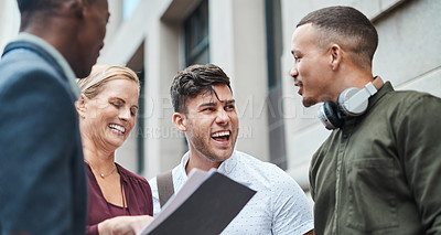 Buy stock photo Shot of a group of businesspeople having an informal meeting against an urban background