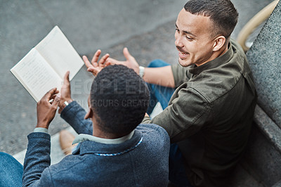 Buy stock photo Shot of two young businessmen having an informal meeting against an urban background