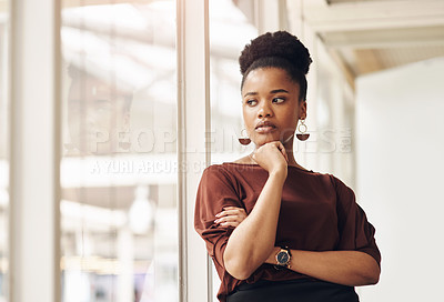 Buy stock photo Cropped shot of an attractive young businesswoman looking thoughtful while standing in the office