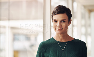 Buy stock photo Cropped portrait of an attractive young businesswoman standing in her office