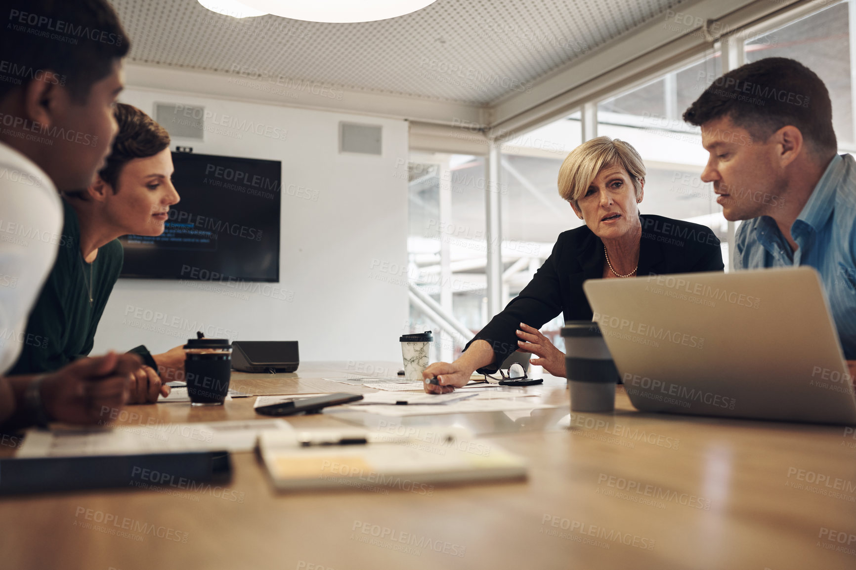 Buy stock photo Cropped shot of a group of business colleagues sitting around a table in the boardroom during a meeting