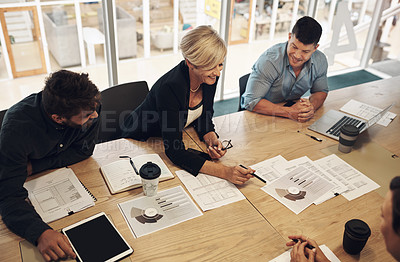 Buy stock photo Cropped shot of a group of business colleagues sitting around a table in the boardroom during a meeting