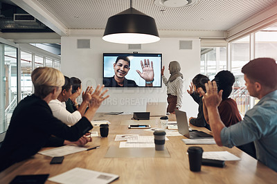 Buy stock photo Cropped shot of a group of business colleagues gathered in the boardroom for a video conference