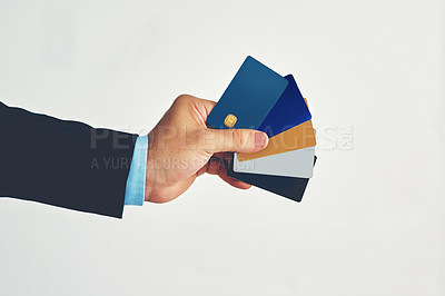 Buy stock photo Studio shot of an unidentifiable businessman holding a selection of credit cards against a white background