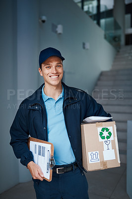 Buy stock photo Cropped shot of a handsome young man on his way to make a delivery