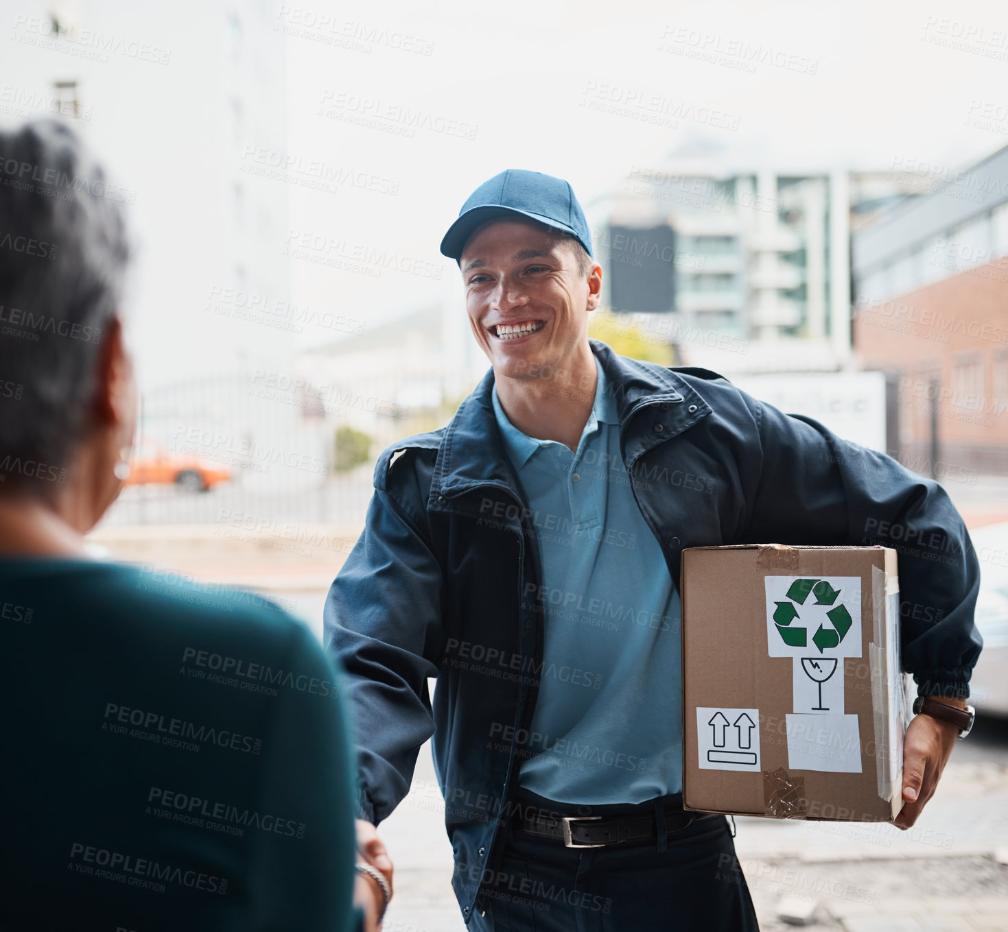 Buy stock photo Cropped shot of a handsome young man delivering a package to a customer