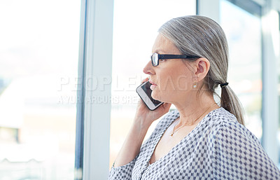 Buy stock photo Shot of a mature businesswoman talking on a cellphone in an office