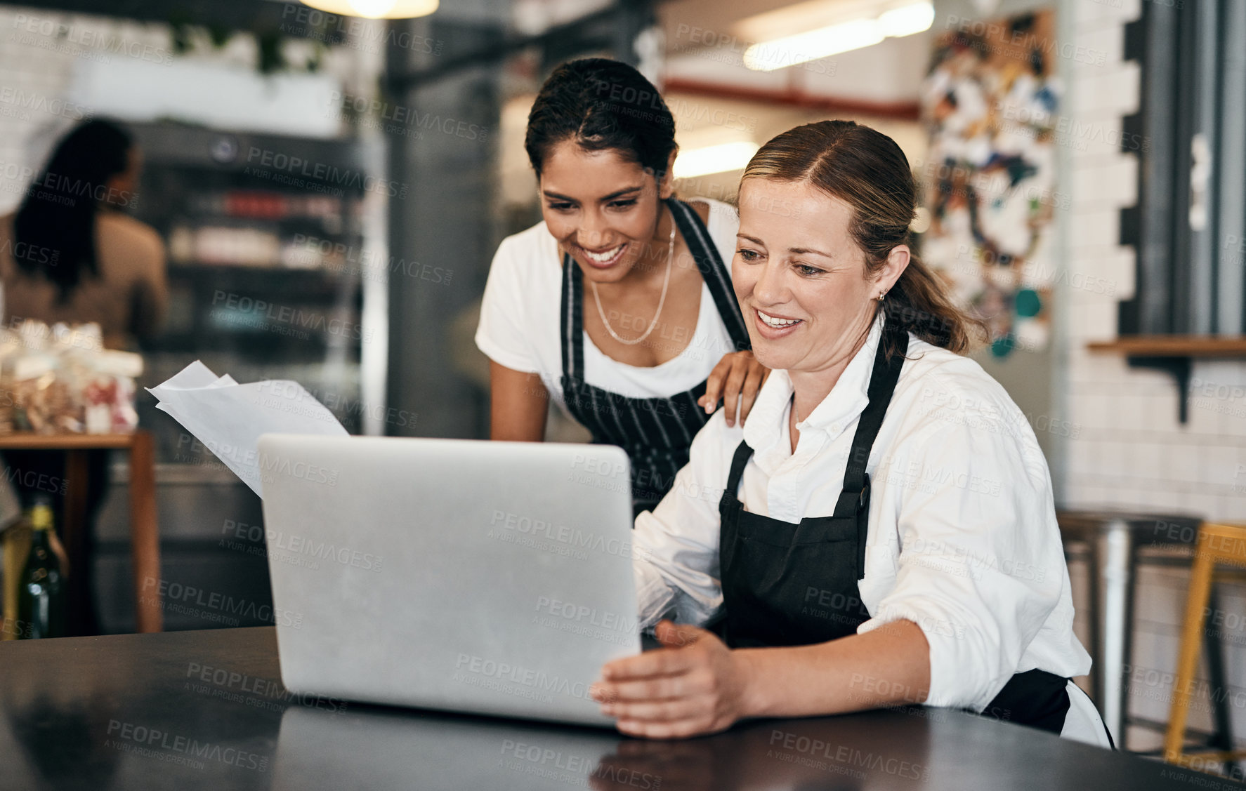 Buy stock photo Cafe employees working on a laptop while planning budget strategy online. Happy coffee manager and colleague learning teamwork in startup business, increase in profit and good reviews on social media