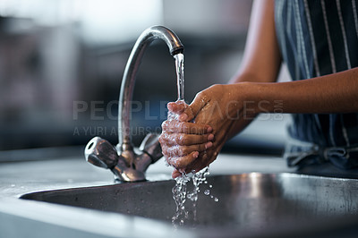 Buy stock photo Cropped shot of a  woman washing her hands in the sink of a commercial kitchen