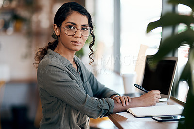 Buy stock photo Shot of a young woman working in a cafe