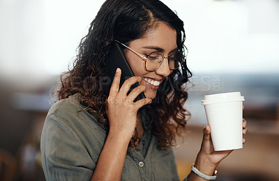 Buy stock photo Young woman talking on her phone, drinking coffee, and smiling in cafe shop. Lady wearing glasses, using technology to network and connect while enjoying a break from work. 