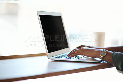 Buy stock photo Cropped shot of a woman using a laptop in a cafe