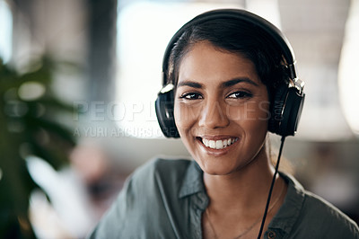 Buy stock photo Shot of a young woman using headphones in a cafe