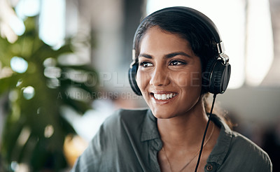 Buy stock photo Happy face of young woman listening to music on headphones, happy and relaxed at home. Female smiling while spending her free time enjoying an audio book or learning a new language on the weekend