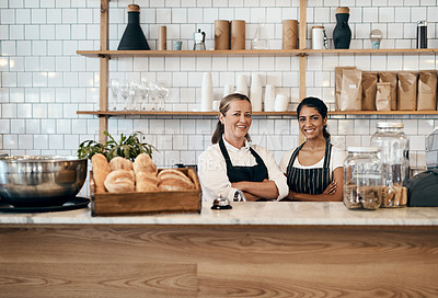Buy stock photo Portrait of two confident women working behind the counter of a cafe