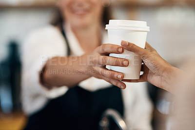 Buy stock photo Cropped shot of a barista handing a customer a cup of coffee at a cafe