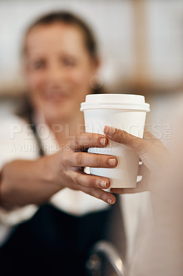 Buy stock photo Cropped shot of a barista handing a customer a cup of coffee at a cafe