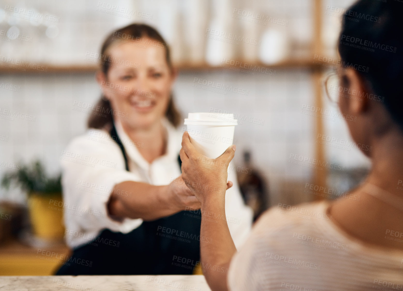 Buy stock photo Customer buying a hot cup of coffee from a happy barista giving good and friendly service at a local cafe shop. Smiling startup entrepreneur and owner handing a drink in a tea store 