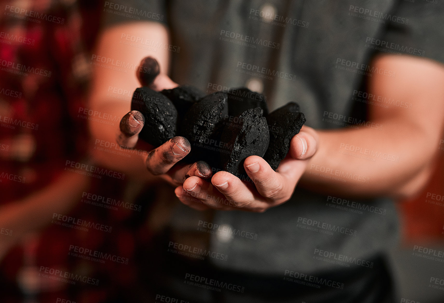 Buy stock photo Closeup shot of an unrecognisable man holding a pile of charcoal