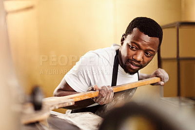 Buy stock photo Cropped shot of a male baker placing bread in a oven