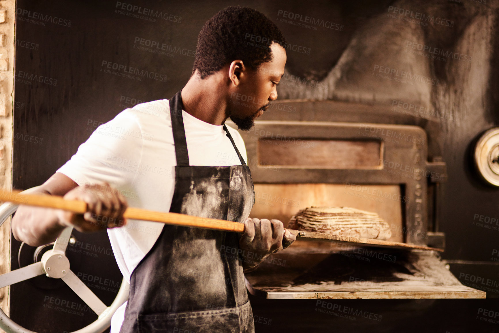 Buy stock photo Black man, rustic bread and oven for baker, small business owner and pastry kitchen workshop. African chef, confidence and catering for coffee shop, person and cafe startup for restaurant industry