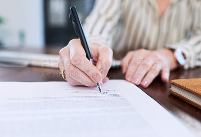 Buy stock photo Closeup shot of an unrecognisable businesswoman signing paperwork in an office