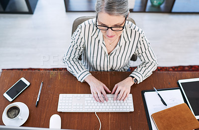 Buy stock photo High angle shot of a mature businesswoman working on a computer in an office