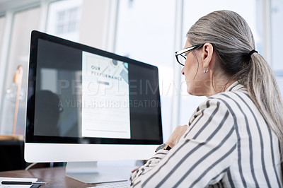 Buy stock photo Rearview shot of a mature businesswoman working on a computer in an office