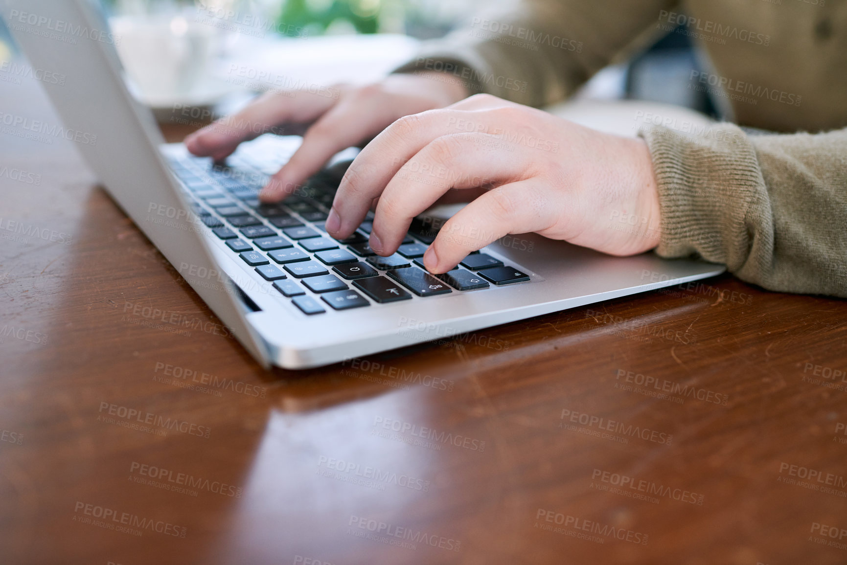 Buy stock photo Closeup shot of an unrecognisable businessman using a laptop in an office