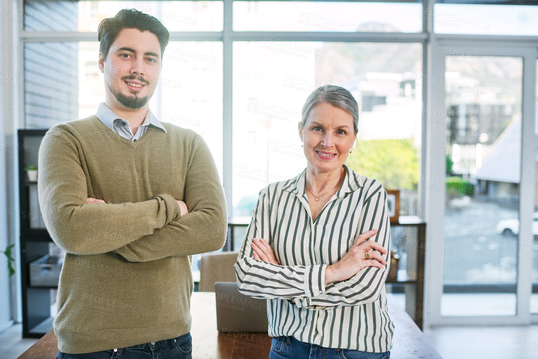 Buy stock photo Portrait of two businesspeople standing together with their arms crossed in an office