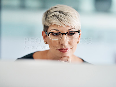 Buy stock photo Shot of a young businesswoman working on a computer in an office