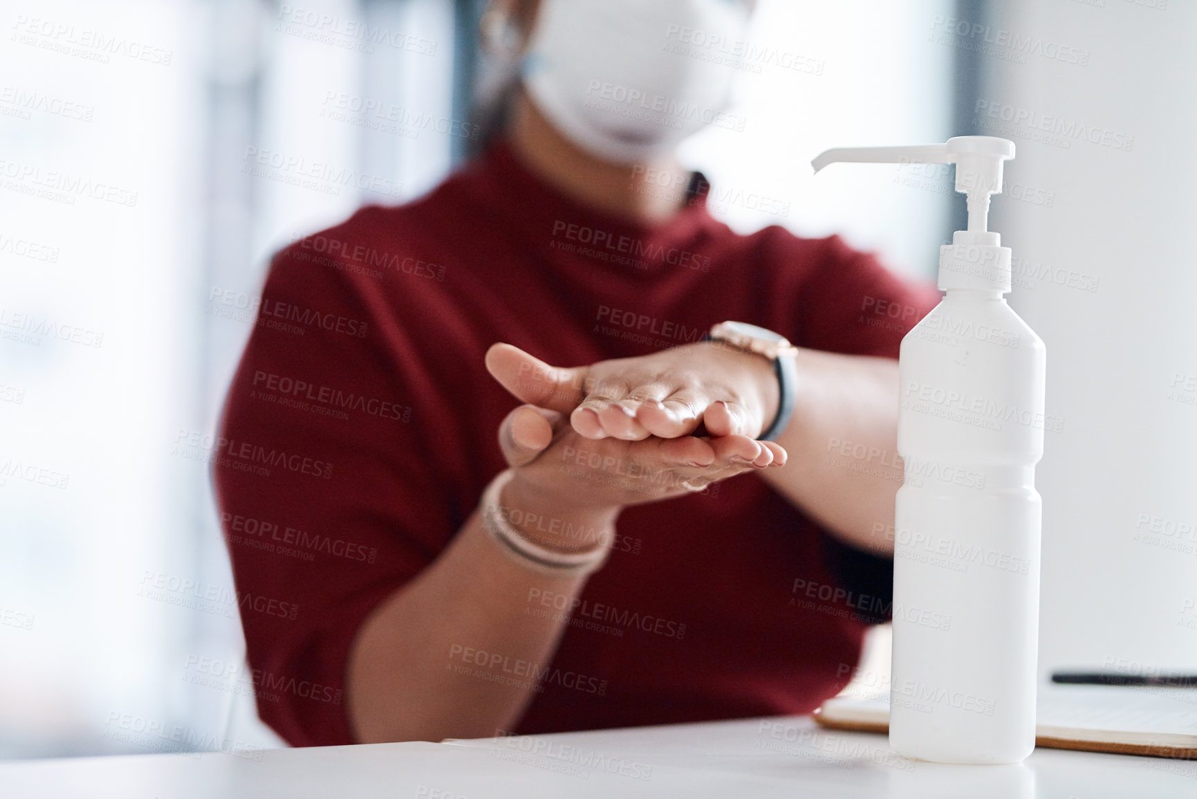 Buy stock photo Closeup shot of an unrecognisable businesswoman using hand sanitiser in an office