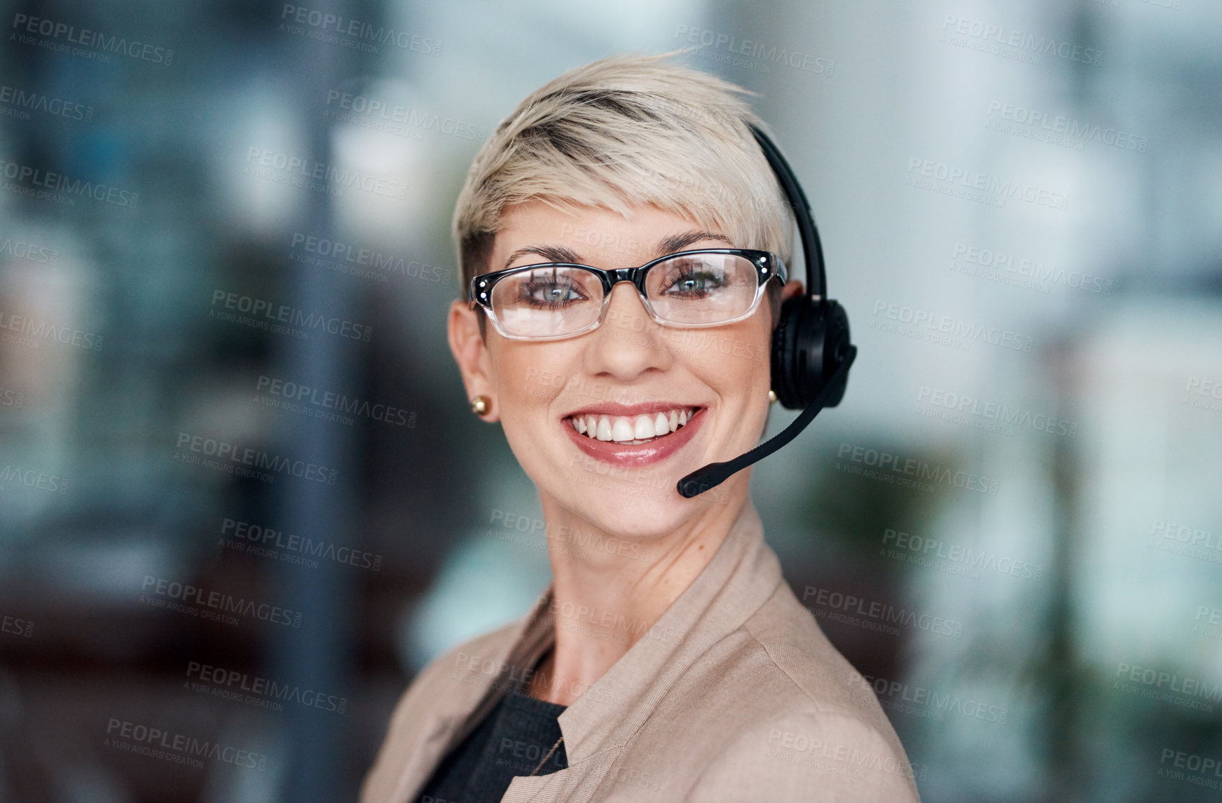 Buy stock photo Portrait of a young businesswoman wearing a headset while working in an office