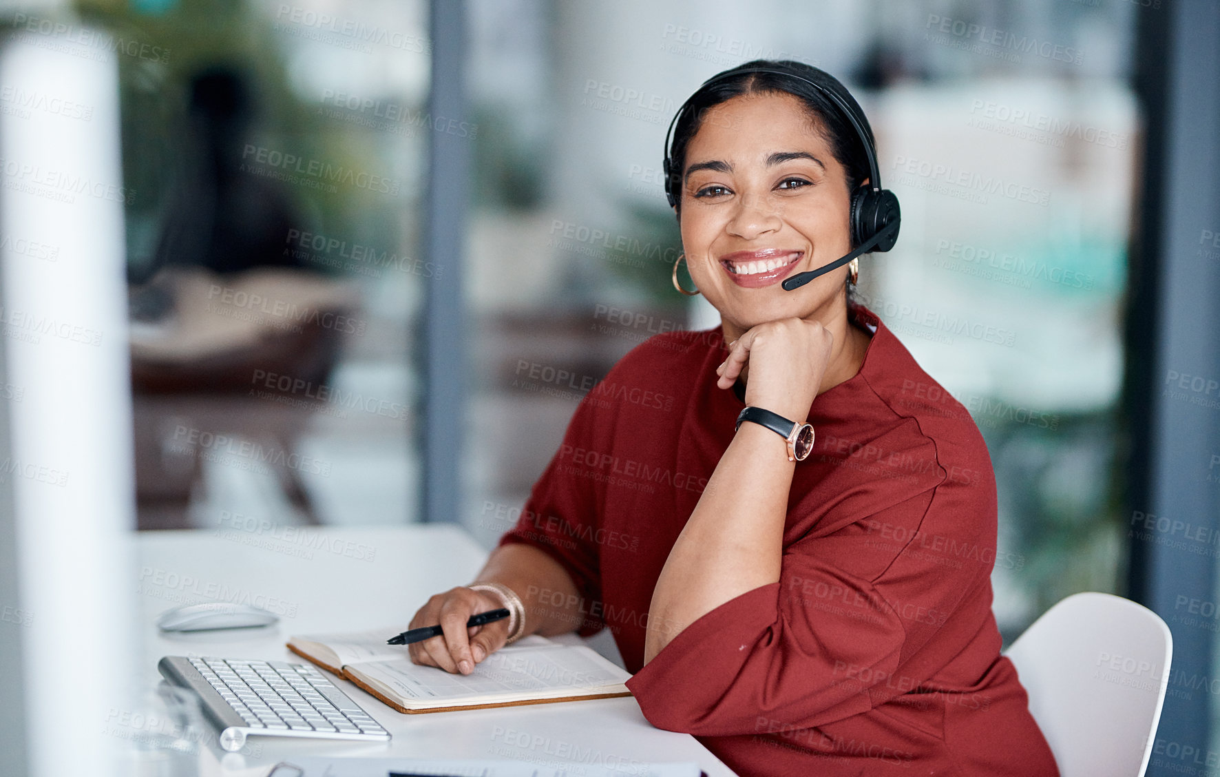 Buy stock photo Portrait of a young businesswoman wearing a headset while working in an office