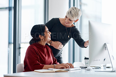 Buy stock photo Shot of a businesswoman helping a colleague in a call centre